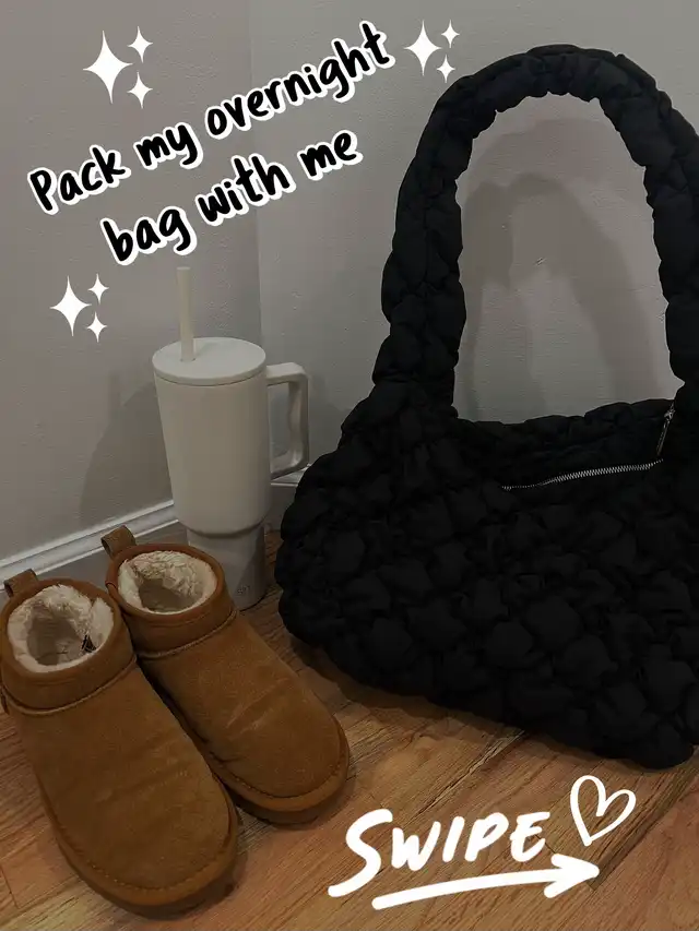 A black quilted overnight bag, a white tumbler, and a pair of brown boots are displayed on a wooden floor, ready for packing. The image includes text indicating a 'pack with me' theme.