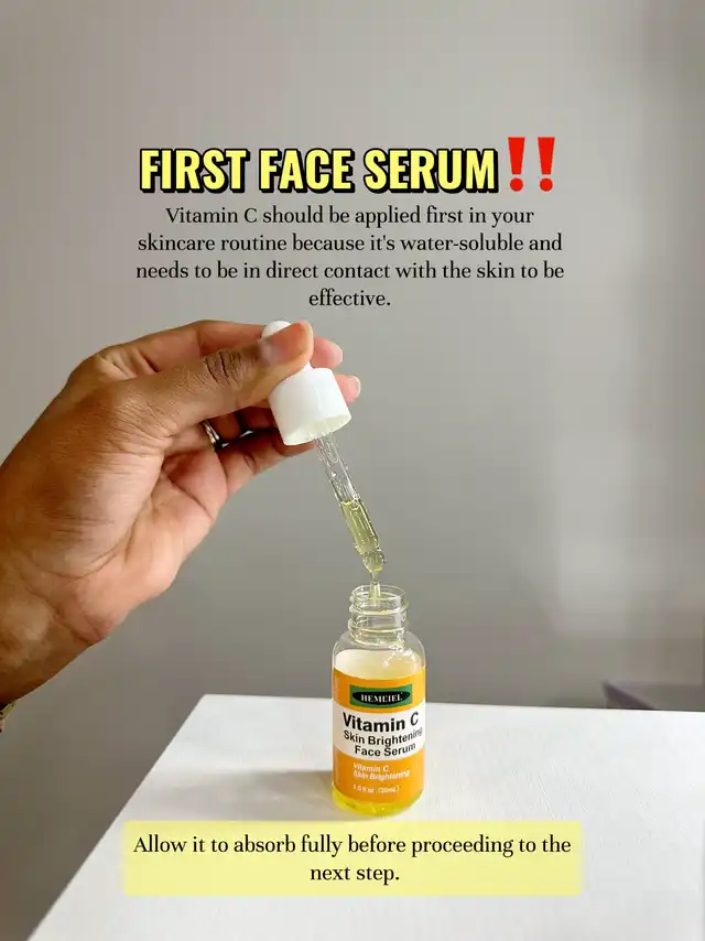 A hand holds a Vitamin C serum bottle with a dropper, illustrating that Vitamin C serum should be applied first in a skincare routine for skin brightening.