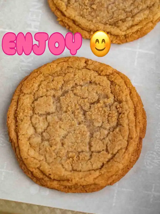 A close-up shows a single golden-brown cookie with a crinkled surface, resting on a light baking sheet. The word "ENJOY" with a smiling emoji is overlaid, suggesting the final product of the chipless cookie recipe.