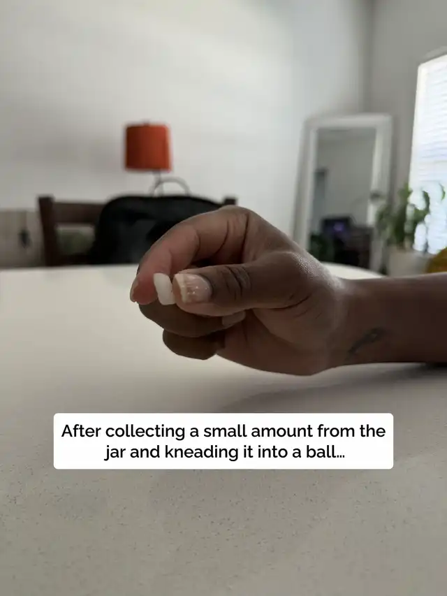 A hand is shown with a small, kneaded ball of museum wax, ready for application. The text describes collecting a small amount from the jar and kneading it into a ball.