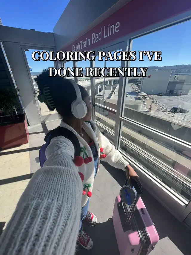 A person wearing headphones and a cherry-patterned cardigan stands in an airport or train station, looking out a window. Text overlay reads "COLORING PAGES I'VE DONE RECENTLY".