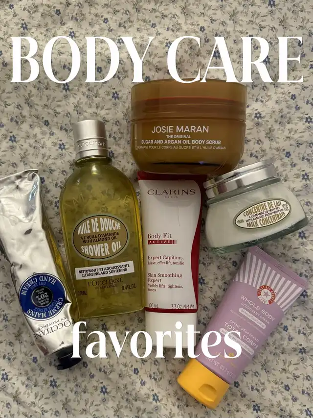 A flat lay of various body care products, including lotions, scrubs, and oils, arranged on a light-colored floral fabric. The text overlay reads 'BODY CARE favorites'.
