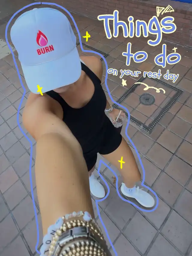 A person wearing a white 'BURN' cap, black athletic outfit, and white sneakers takes a selfie outdoors. The image has 'Things to do on your rest day' overlaid, highlighting the theme of rest day activities.