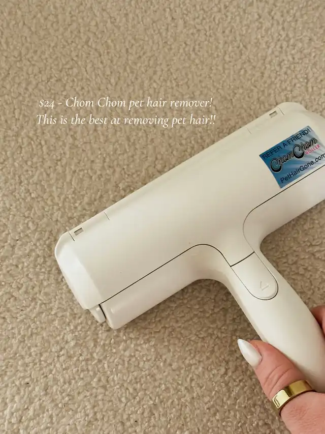 A hand holds a white pet hair remover tool, the Chom Chom, against a light-colored carpet. The text emphasizes its effectiveness for removing pet hair from surfaces.